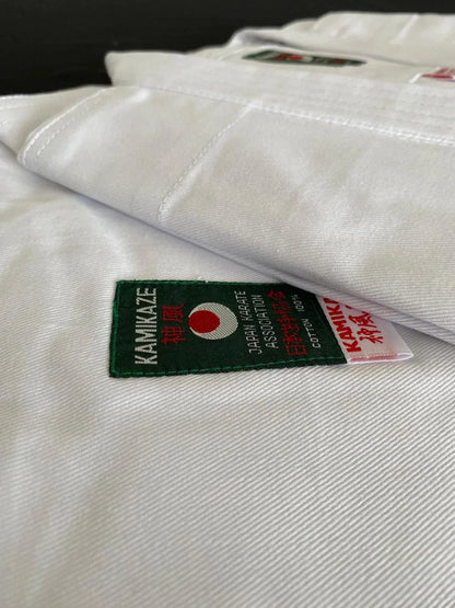 Close-up of white karate gi fabric with Kamikaze Japan Karate Association patch and label.