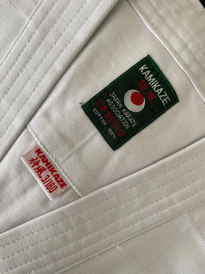 Close-up of white karate gi fabric with Kamikaze and Japan Karate Association labels